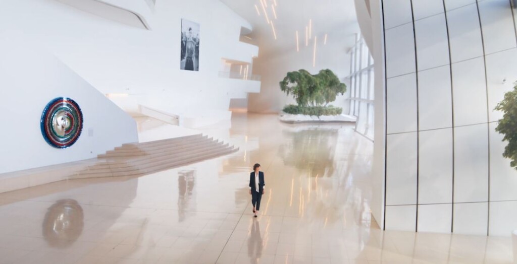Une femme brune marchant dans un grand bâtiment illustrant le tournant pour l'entreprise